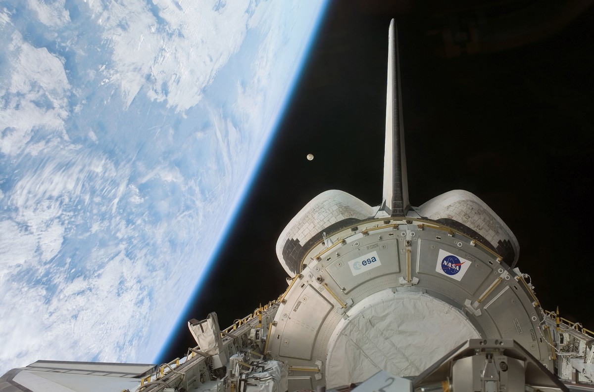 Backdropped by the blackness of space and Earth's horizon, the Harmony node in Space Shuttle Discovery's payload bay is featured in this photo taken by an STS-120 crew member on Oct. 24, 2007. Earth's moon is visible at center. Credit: NASA/JSC.