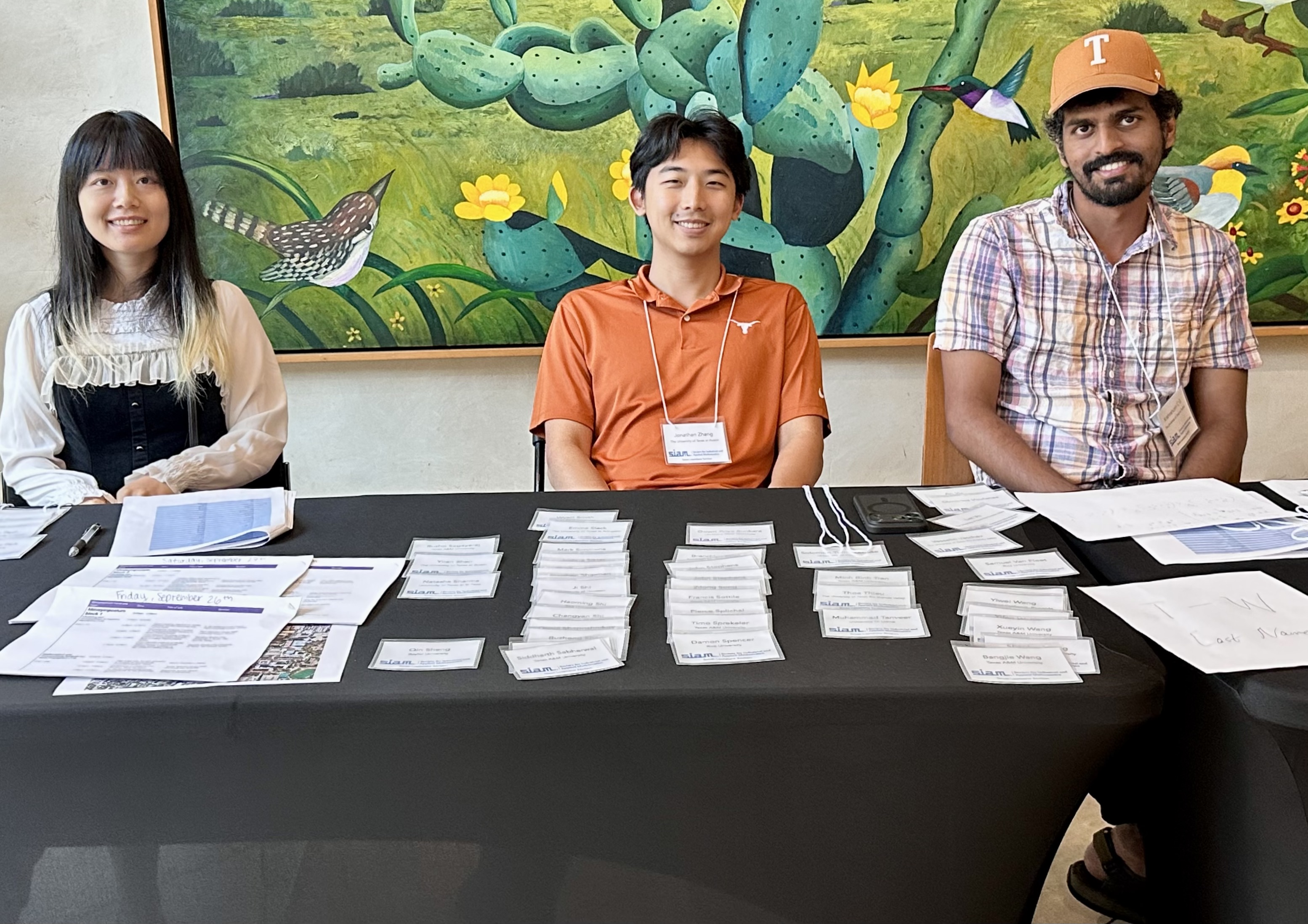 Volunteers welcome attendees. L-r: Yimin Zhu, Jonathan Zhang, Krishnanunni C G.