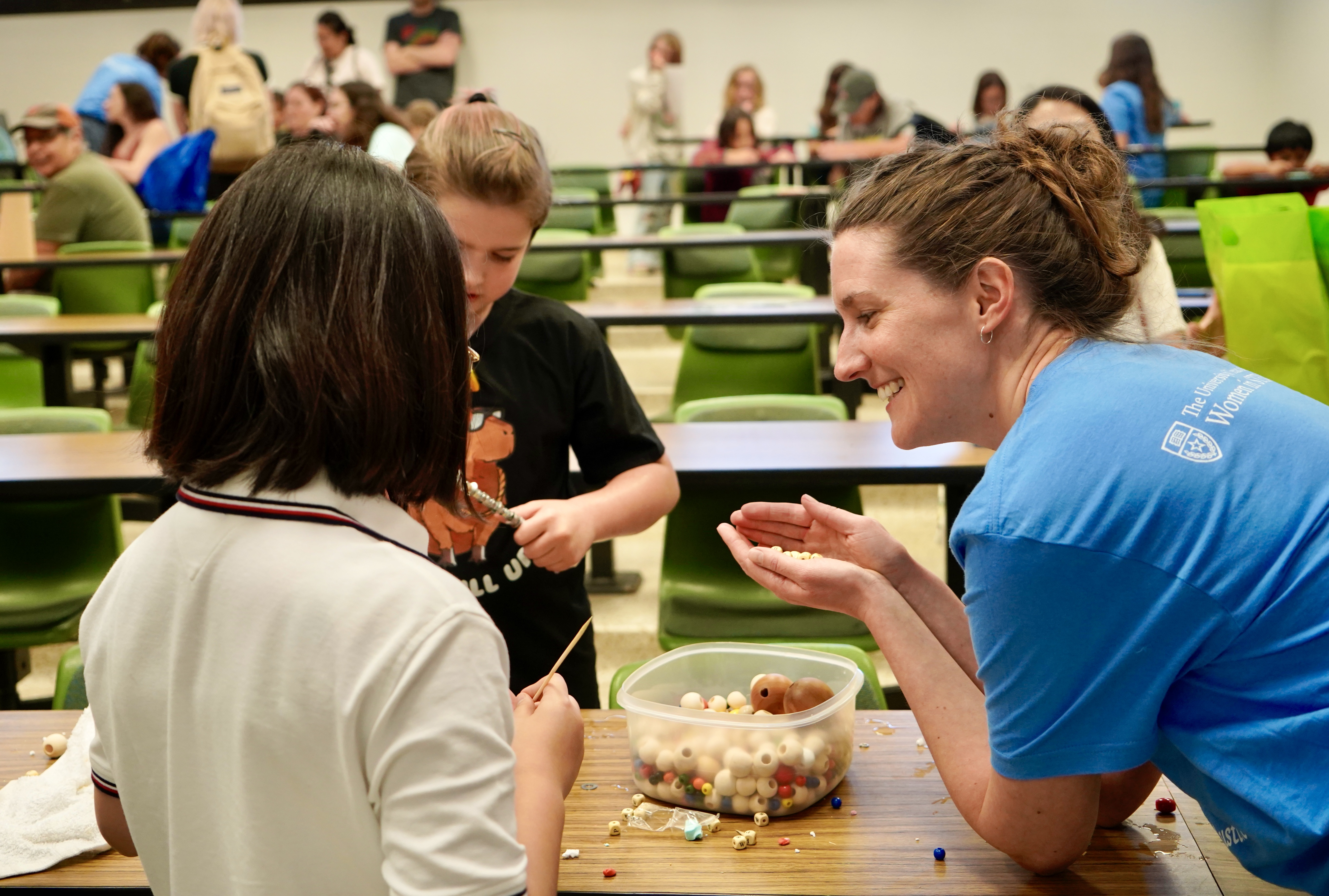 Research Associate Helen Pillar helps two participants explore the concept of buoyancy.